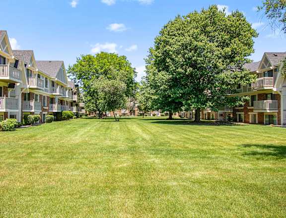 a large green lawn in front of apartments at Briarwood Apartments in Benton Harbor, MI