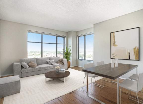 a living room with a couch and a dining room table
