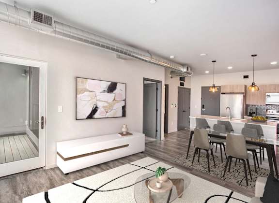 a living room with a couch and a table with chairs