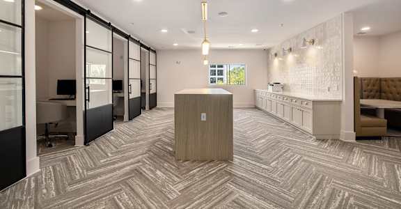 A modern office space with a reception desk and a view of the outdoors.