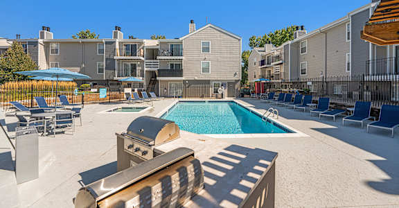 our apartments have a pool and lounge areas with chairs and umbrellas