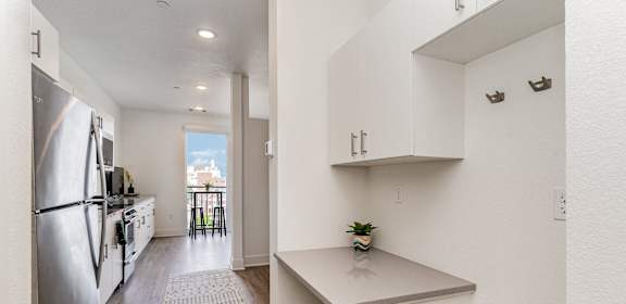 a renovated kitchen with white cabinets and stainless steel appliances  at City View Apartments, Michigan