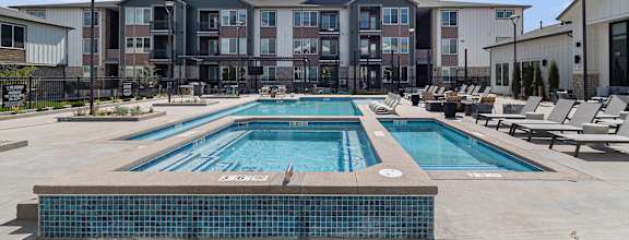 A large swimming pool in front of a building.