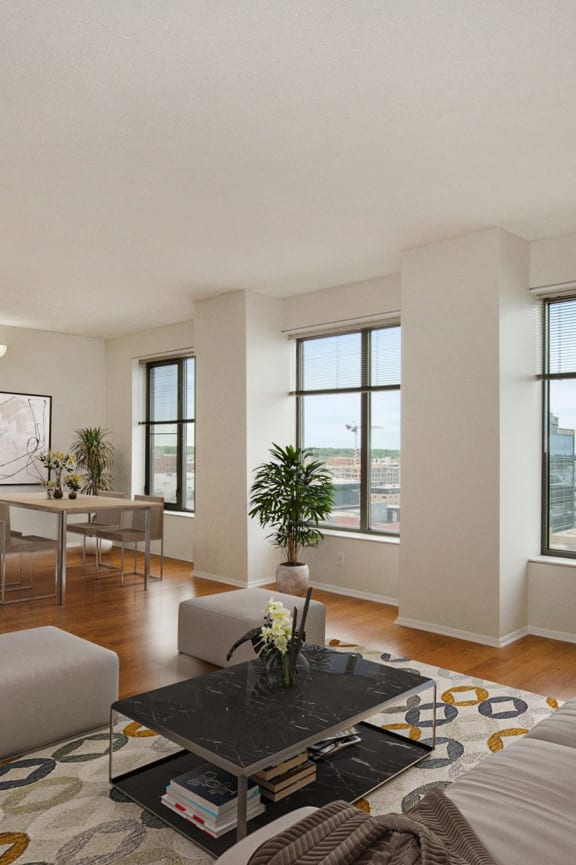 a bedroom with hardwood flooring and three windows