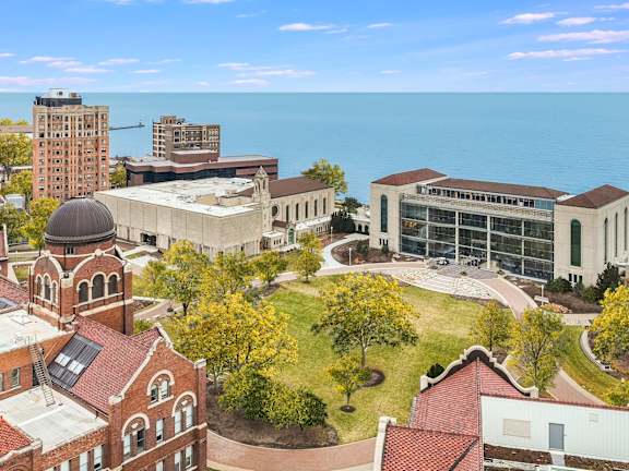 an aerial view campus with the ocean in the