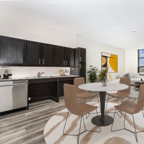 a living room and kitchen with a table and chairs