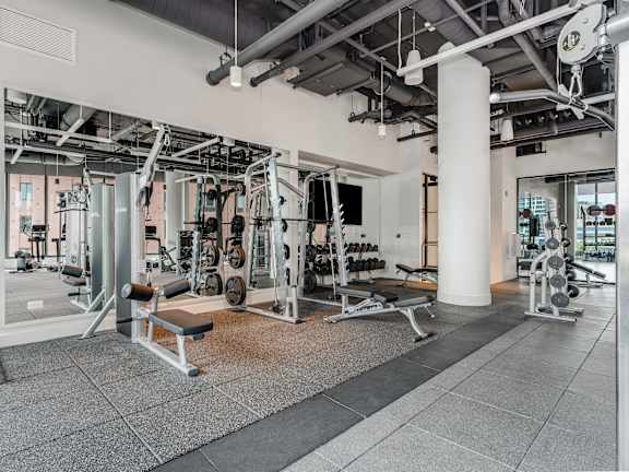a fitness center with weights machines and other gym equipment