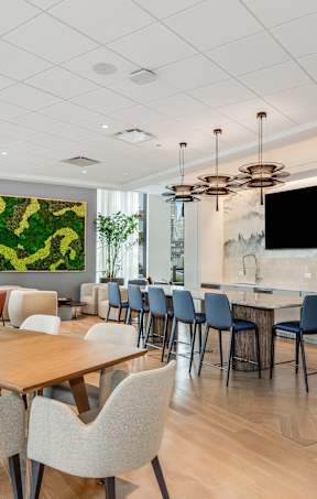 A modern dining room with a large painting on the wall.