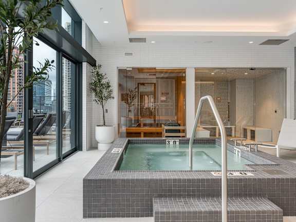 a large jacuzzi pool in the middle of a room with glass doors  at Cassidy on Canal, Chicago, 60606