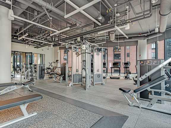 a gym with weights and other exercise equipment in a building