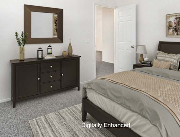 A bedroom with a large bed and a dresser with a mirror above it.