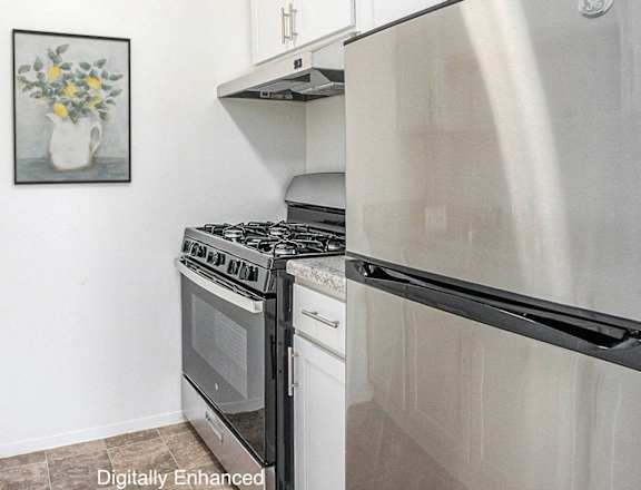 A kitchen with a stove, oven, and sink.