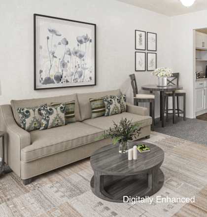 A living room with a couch, coffee table, and a painting on the wall.