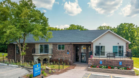a brick and with a porch and a blue sign