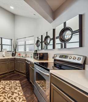 A kitchen with a bar area and chairs.