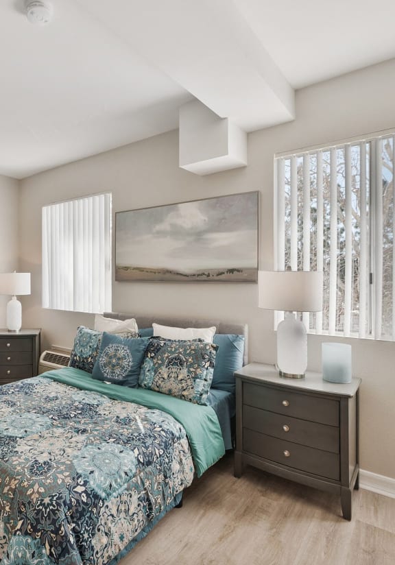 a bedroom with a bed and a chair and a window