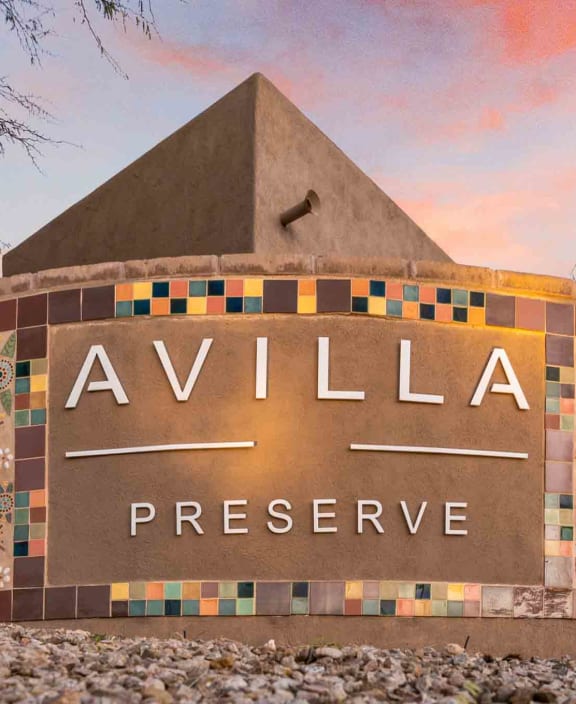 the sign for valley preserve in front of a sunset