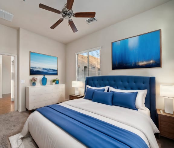 a bedroom with a large bed and a ceiling fan