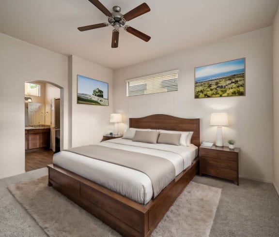 a bedroom with a large bed and a ceiling fan