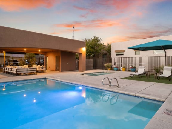 a swimming pool in front of a house with a pool