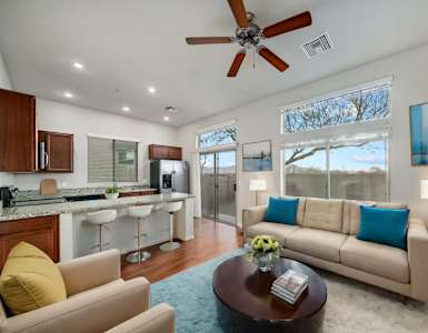Spacious Living Room and Kitchen with Breakfast Bar at Avilla Preserve Apartment Homes in Tucson Arizona