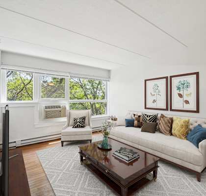 a living room with a couch and a coffee table at Baystate Place Apartments in 414 Chestnut Street Springfield