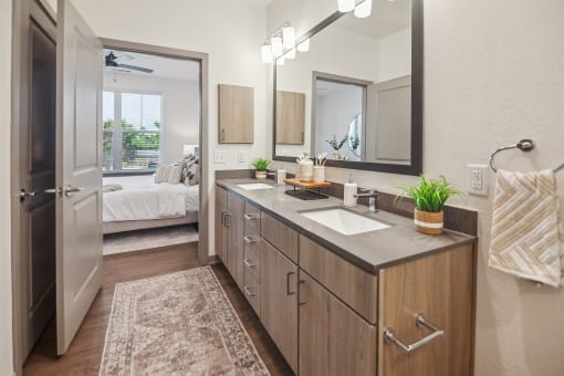 a bathroom with a sink and a mirror and a door to a bedroom  at Palm Grove, Ellenton, FL, 34222