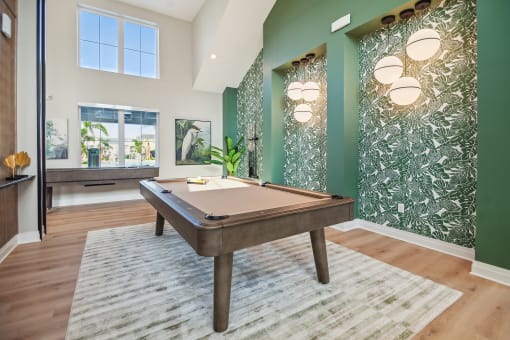 a billiards table in a game room with green walls  at Palm Grove, Ellenton, FL