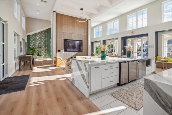 a kitchen with a large island and a living room with a tv  at Palm Grove, Florida, 34222