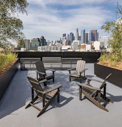 a patio with chairs and a view of the city