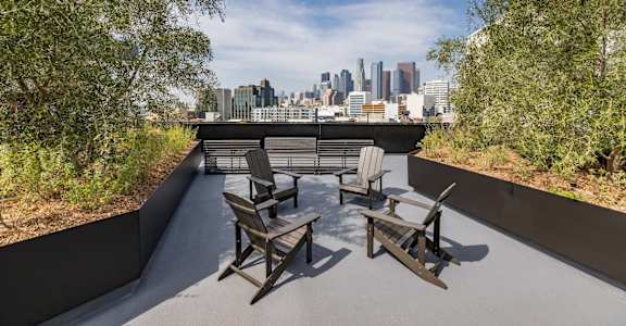 a patio with chairs and a view of the city