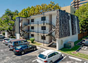 Thumbnail 14 of 17 - Exterior of building: three stories, parking log, and outdoor staircase