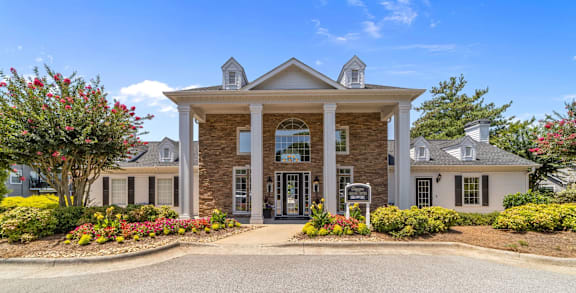 A large house with a front yard and a driveway.