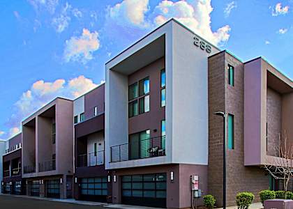 a modern apartment building with a blue sky in the background