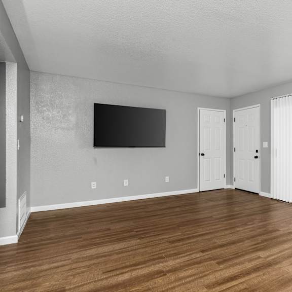 Room with wooden floor at Redwood Cove Apartments, Chico