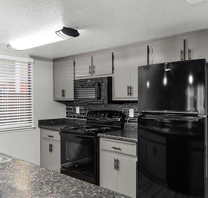 Kitchen black appliances at Redwood Cove Apartments, Chico