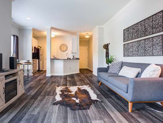 Large living room off of a kitchen with wood style flooring at Dwell at Naperville, Illinois, 60563