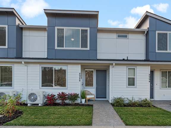 a white house with a blue roof and a lawn at Thrive at Green Mountain, Camas, Washington