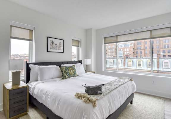 a bedroom with a large bed and a large window