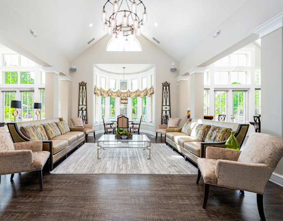 a living room with couches and chairs and a chandelier