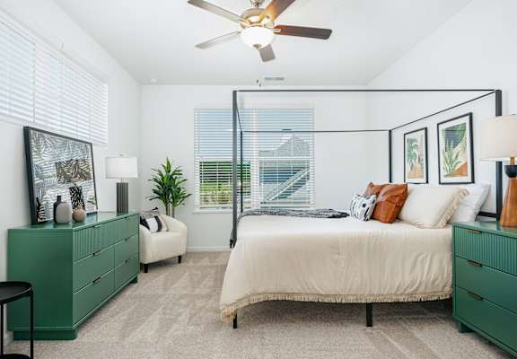 a bedroom with a bed and a ceiling fan