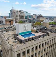 A large building with a swimming pool on the roof.