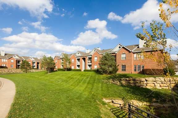A row of houses with a green lawn in front.