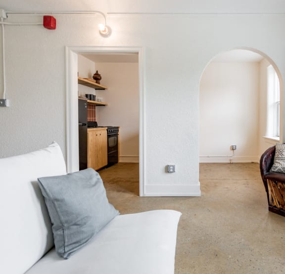 a bedroom with a bed and bookshelves     and a chair