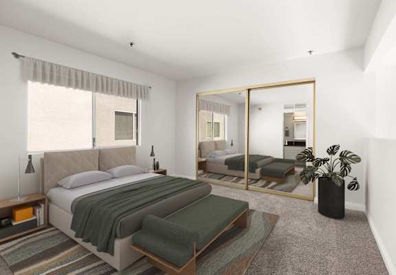 A bedroom with a large bed and a mirror on the wall.