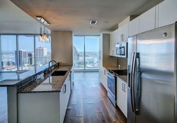 A modern kitchen with a view of the city.