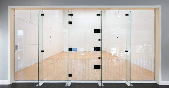 A room with a wooden floor and glass walls.