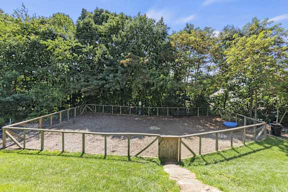 A trampoline in a backyard surrounded by a fence at River Mill Lofts & Skyloft in Asheville, 28803
