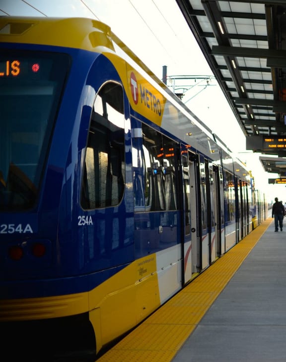 a blue and yellow train at a train station
