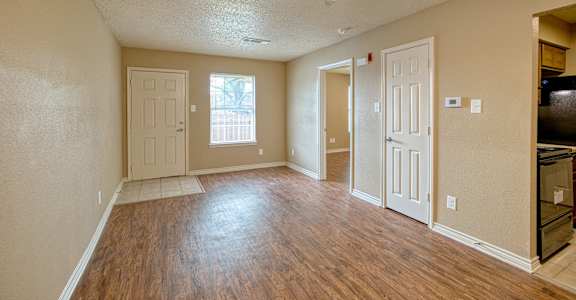 A room with wooden floors and a ceiling fan.
